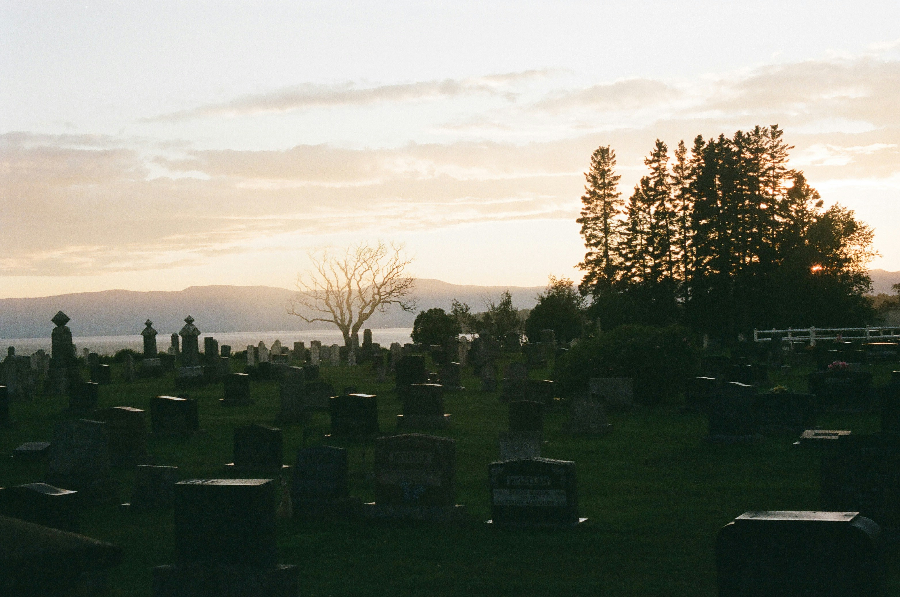 a cemetery with a lake in the background