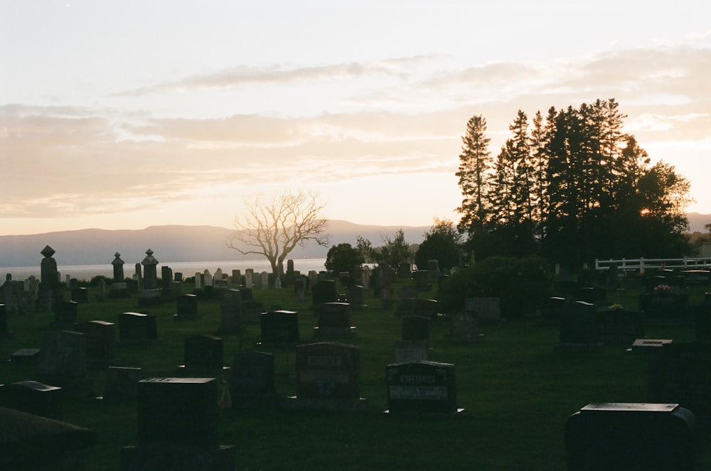 a cemetery with a lake in the background