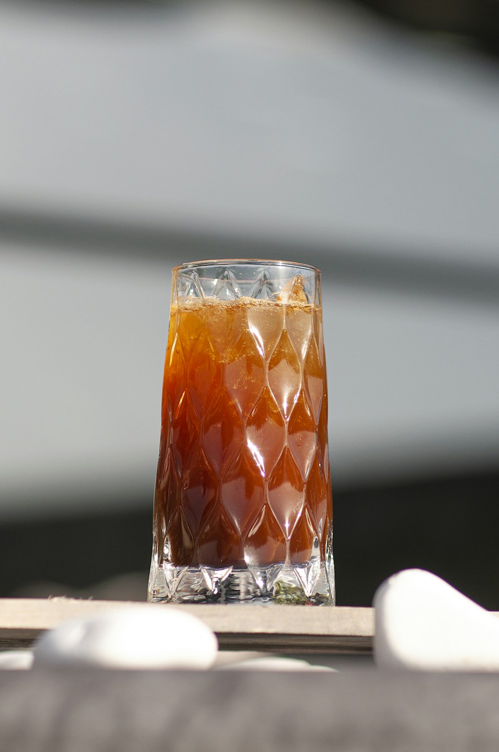 a glass filled with liquid sitting on top of a table