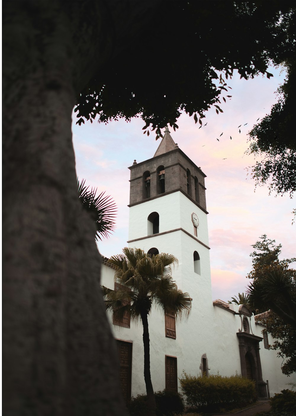 a tall white building with a clock on it's side