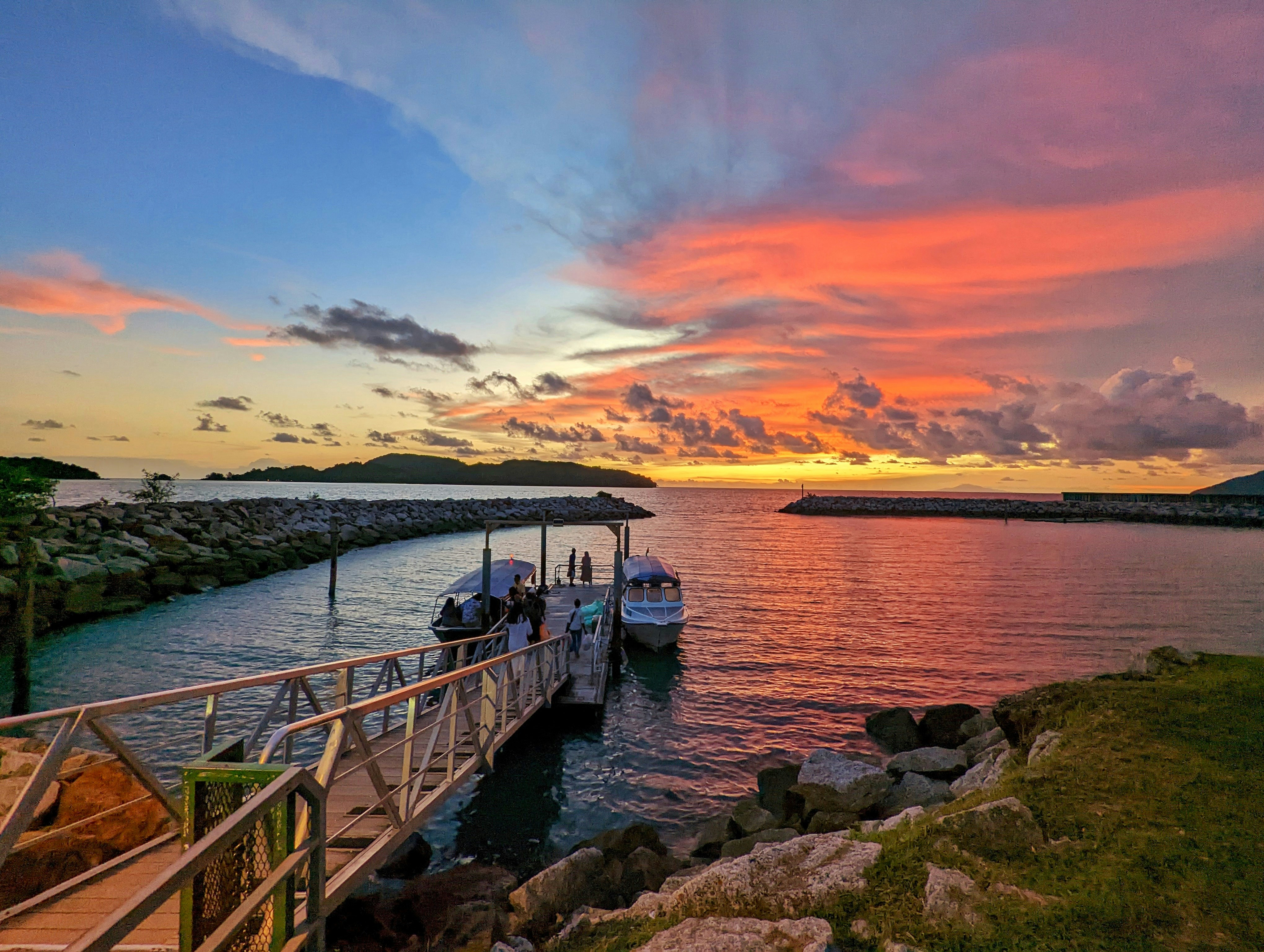 a boat is docked in the water at sunset