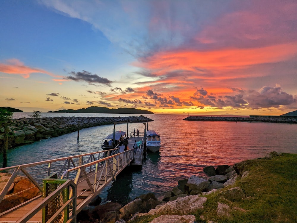 a boat is docked in the water at sunset