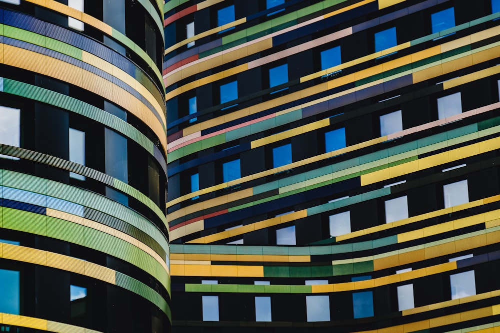 a multicolored building with a clock on the front of it