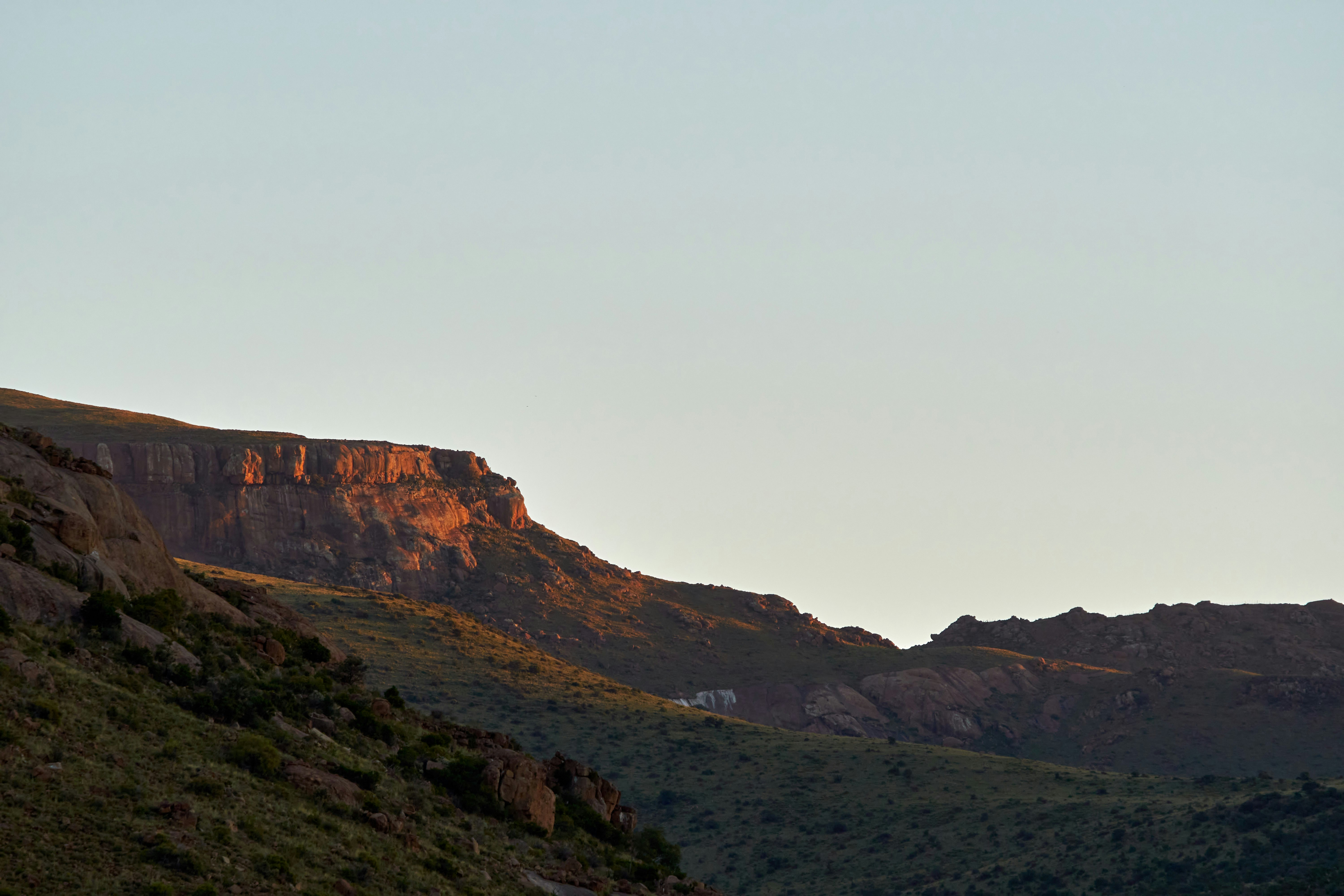 a hill with a mountain in the background