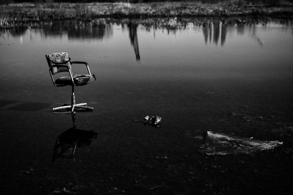 a chair sitting in the middle of a body of water
