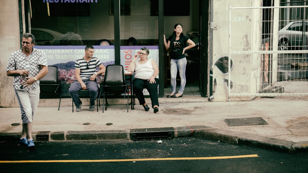 a group of people sitting outside of a building