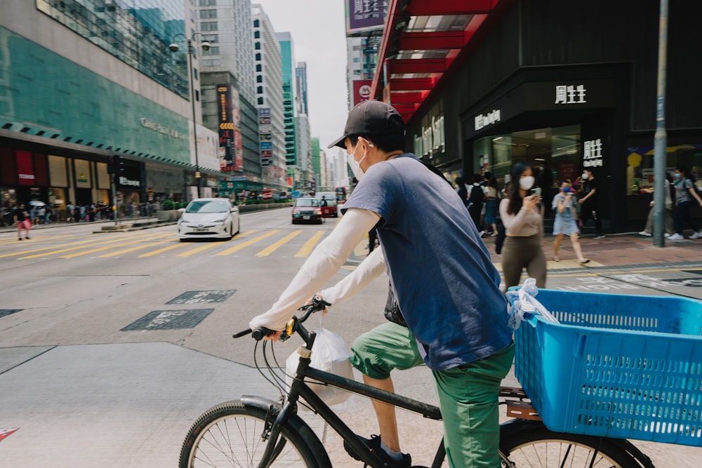 a man riding a bike down a city street