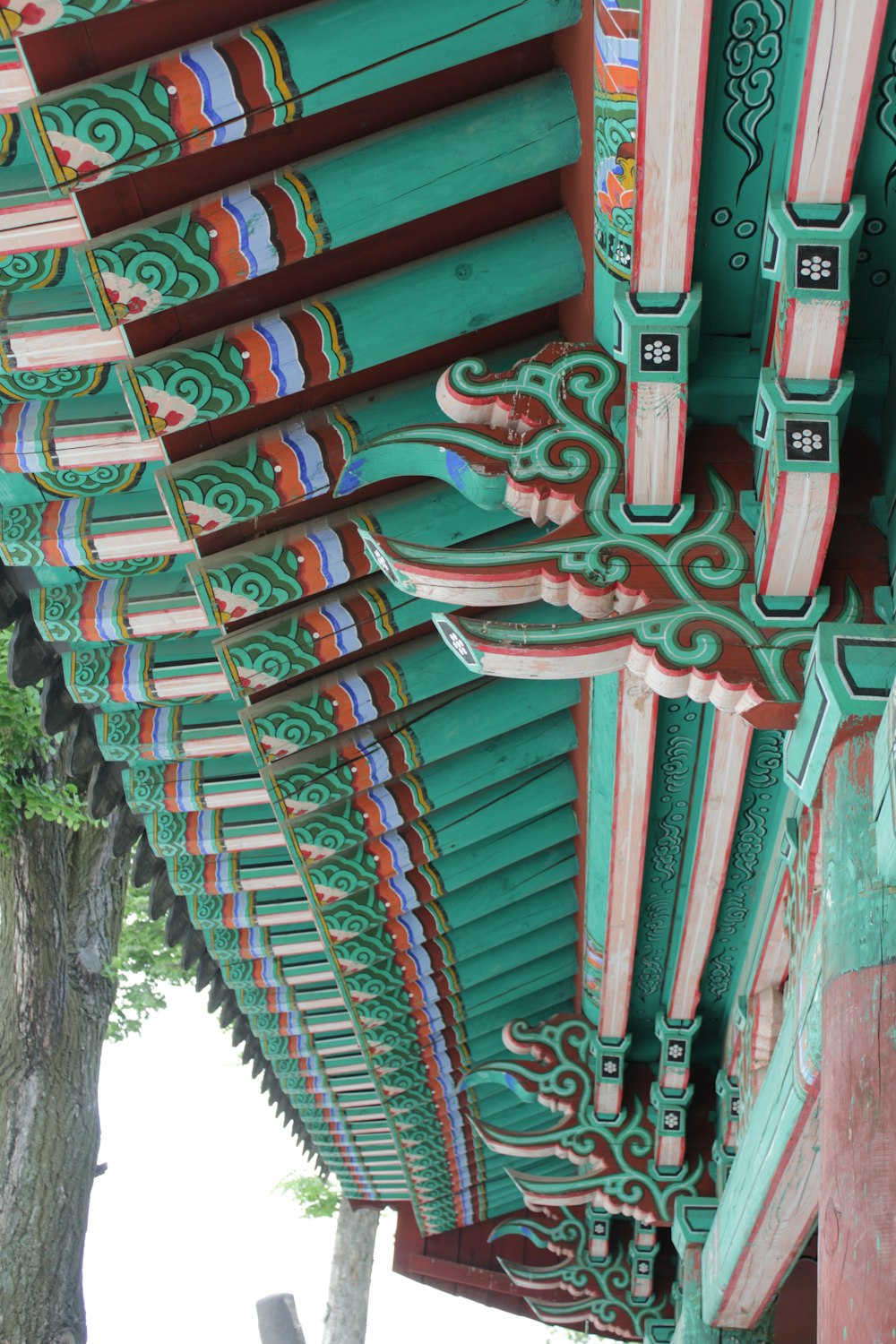 the roof of a building is painted green and red