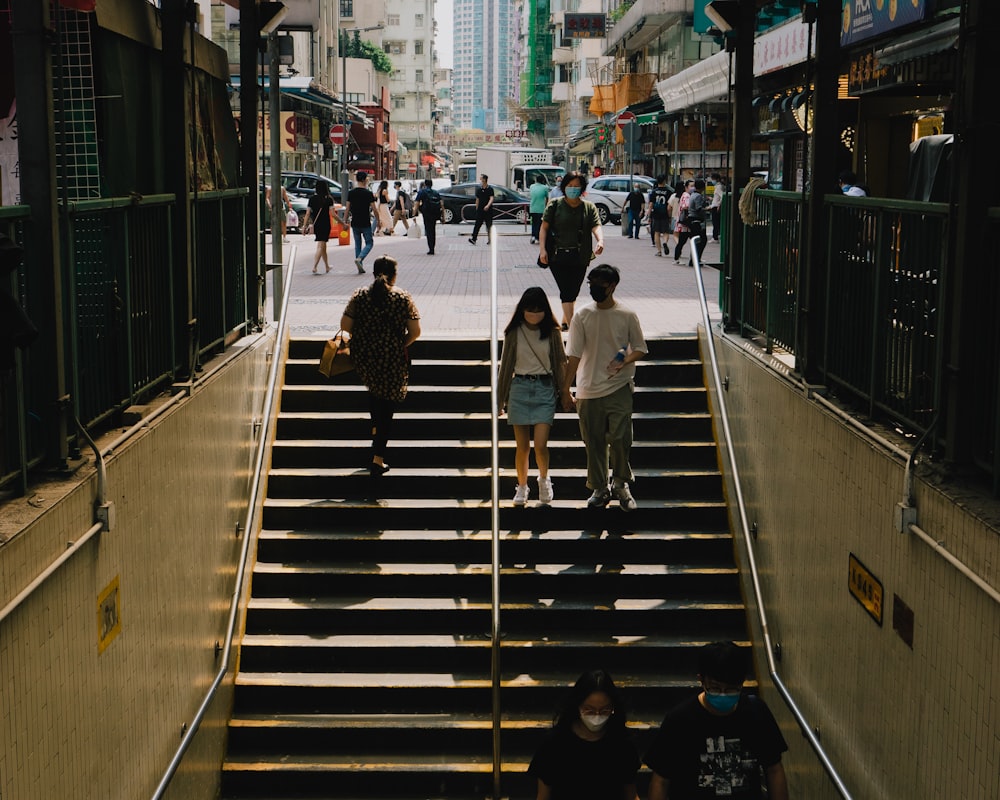 a group of people walking down a set of stairs