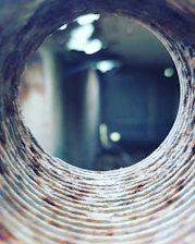 a round hole in a brick wall with a blurry background