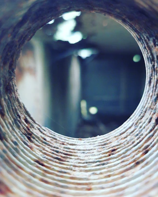 a round hole in a brick wall with a blurry background