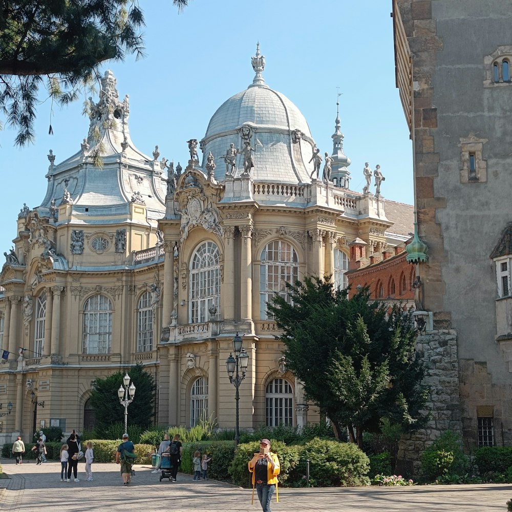 a group of people walking around a large building