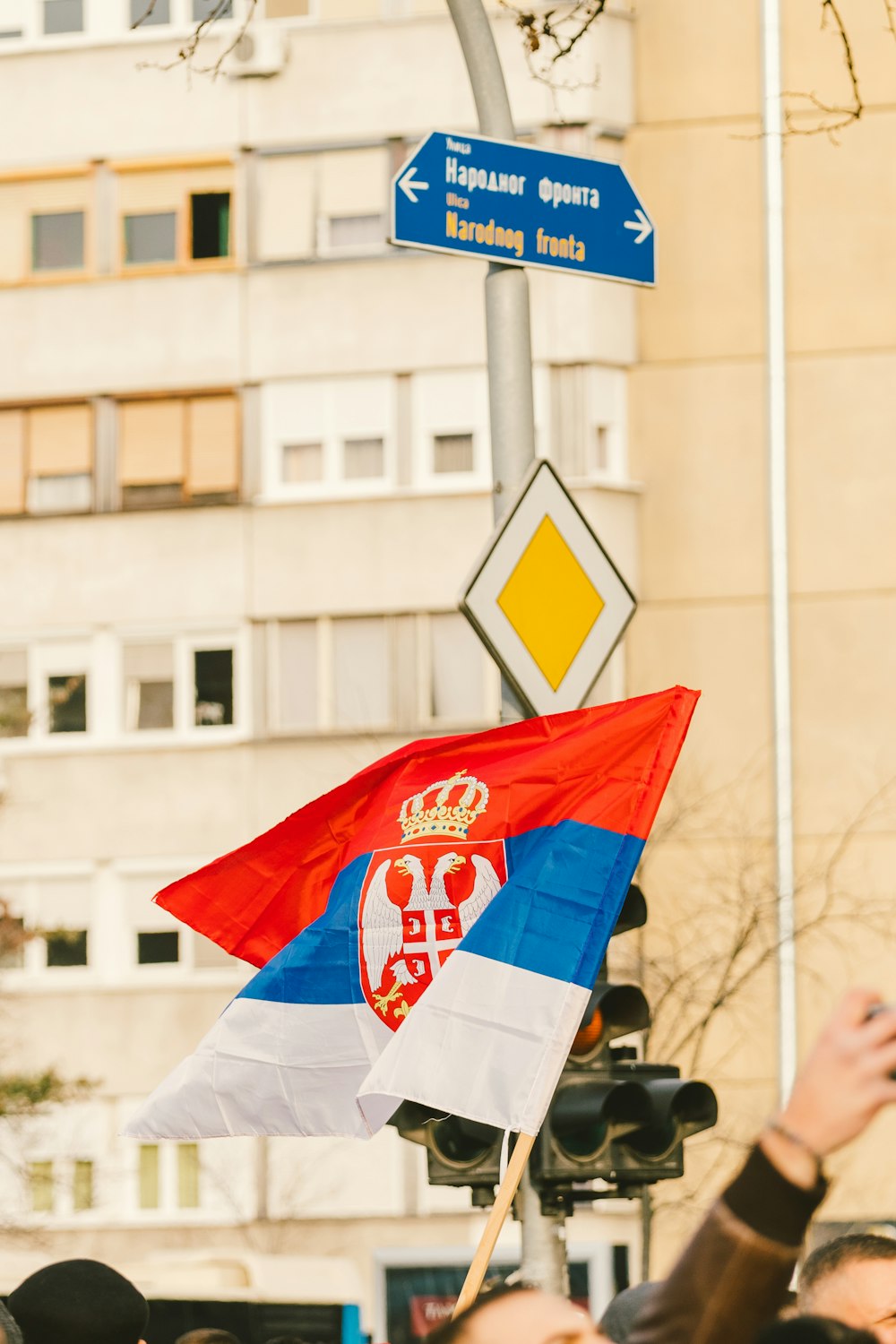 a group of people standing under a street sign