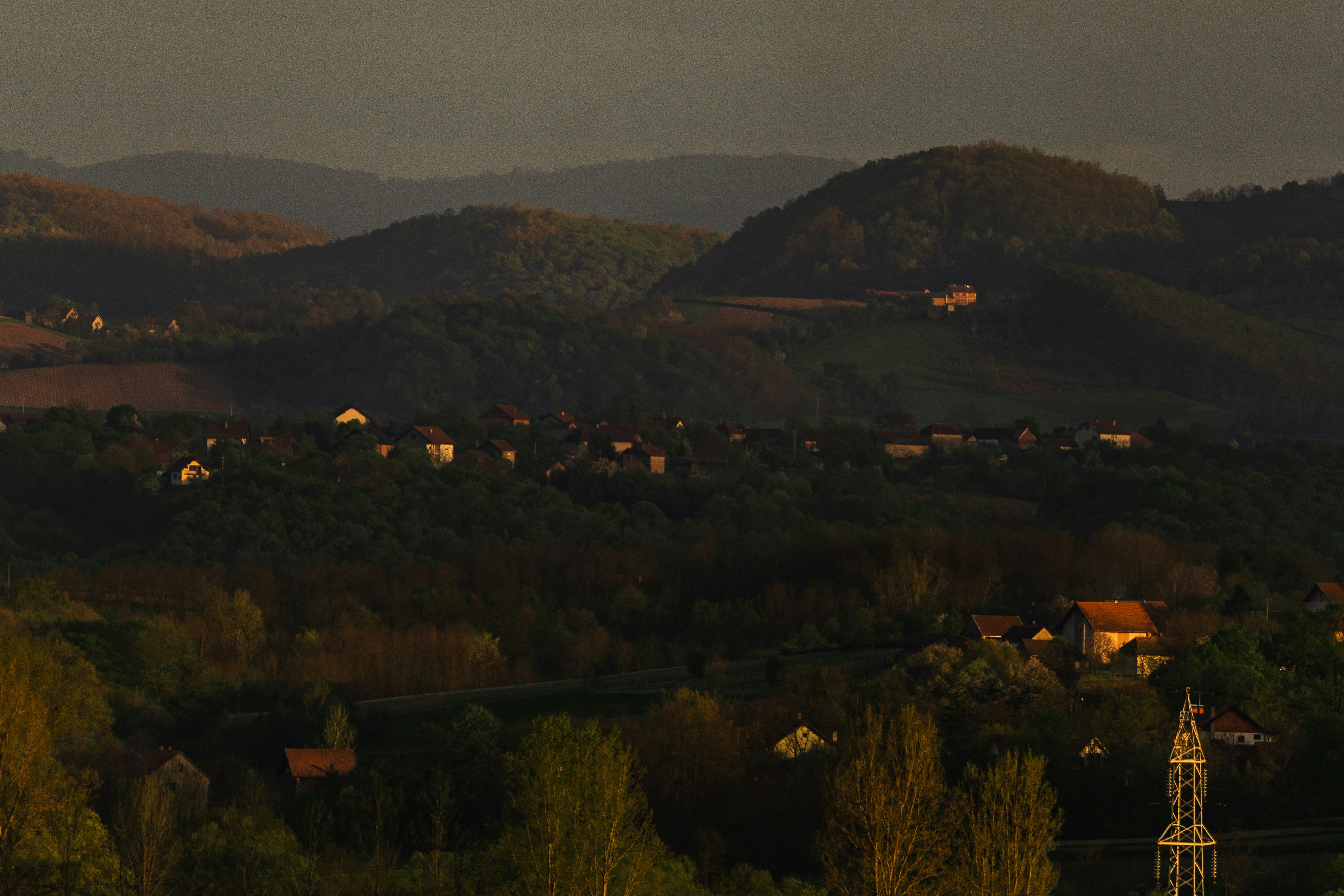 a view of a town in the distance with mountains in the background