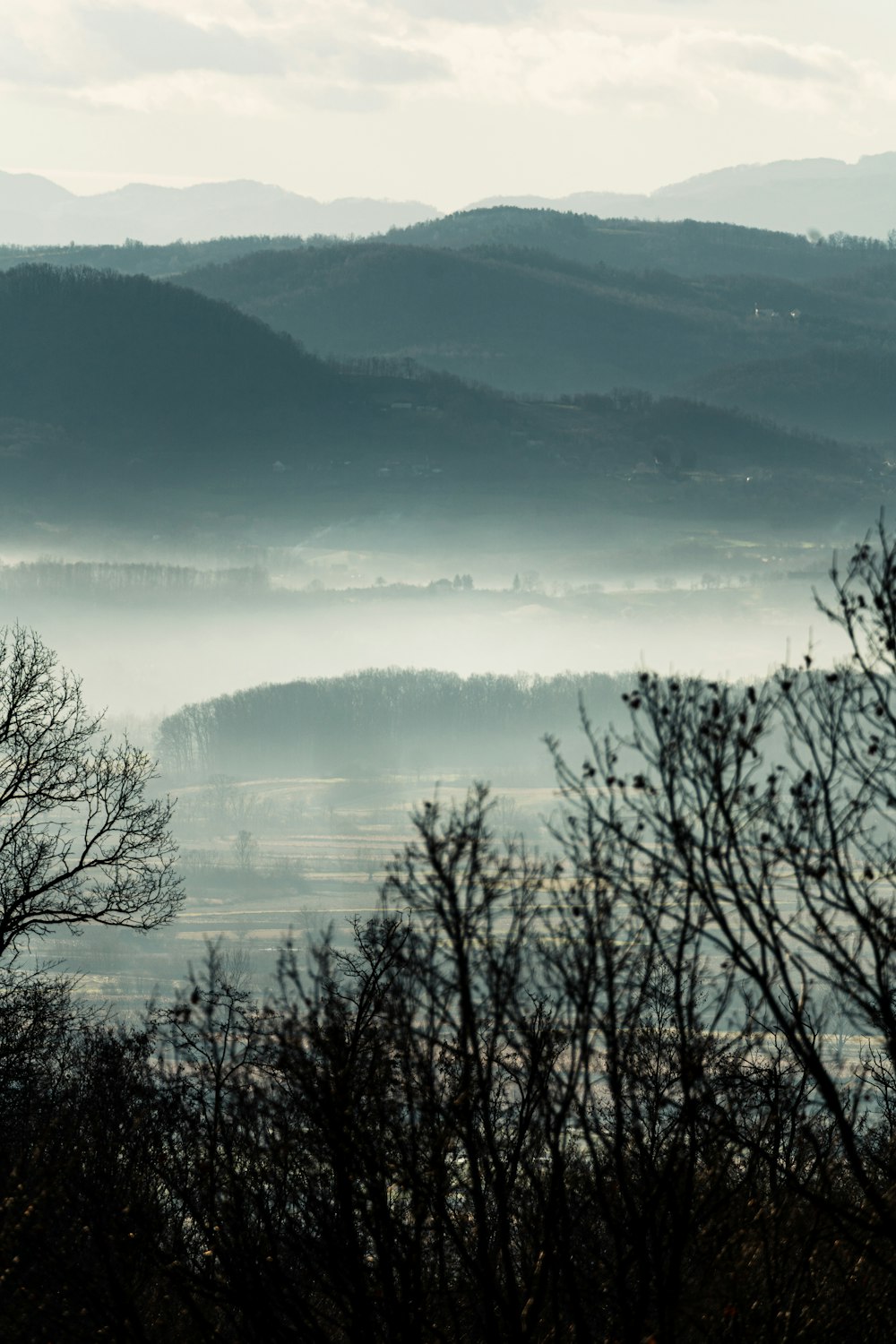 a view of a mountain range covered in fog