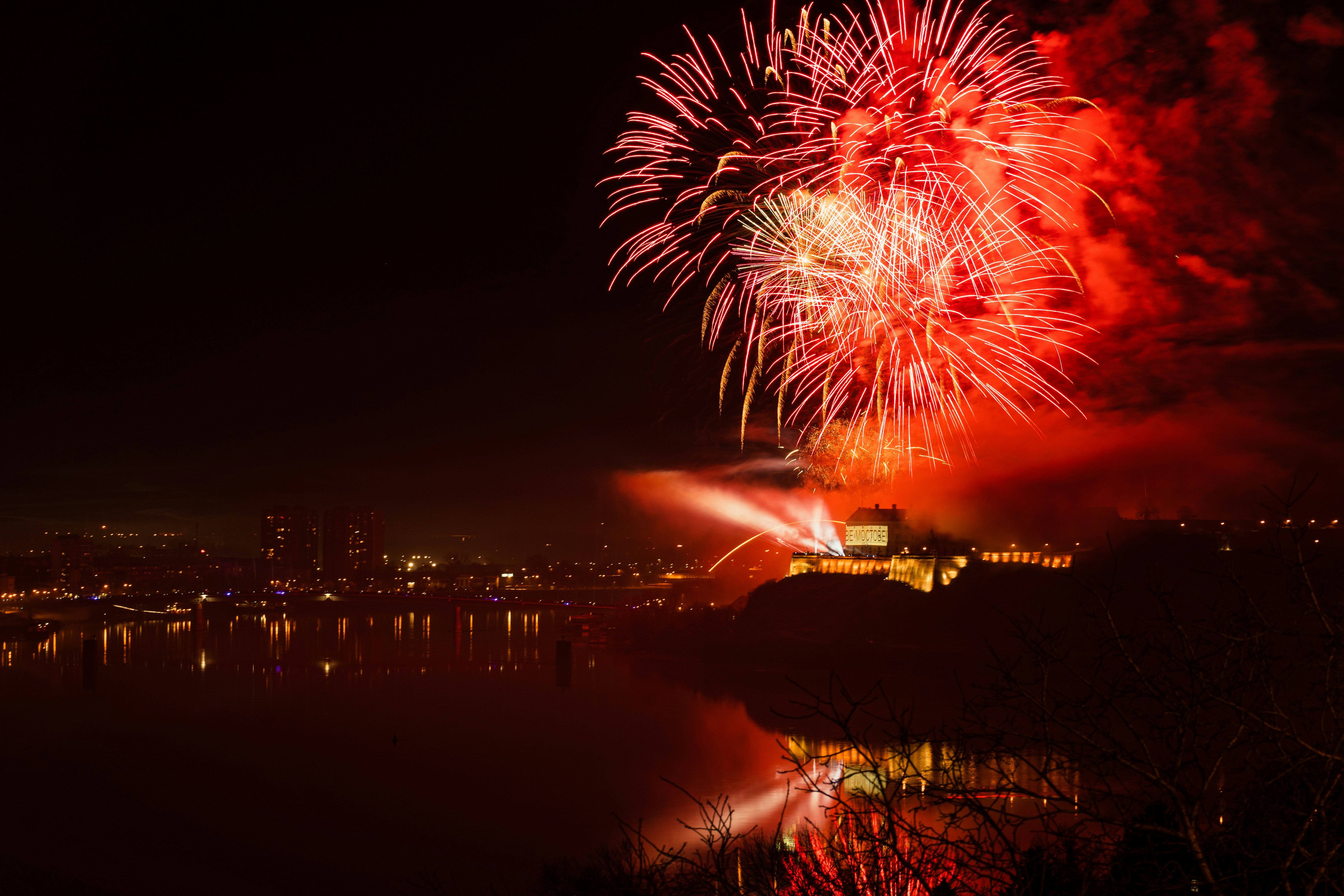 a fireworks display over a city at night