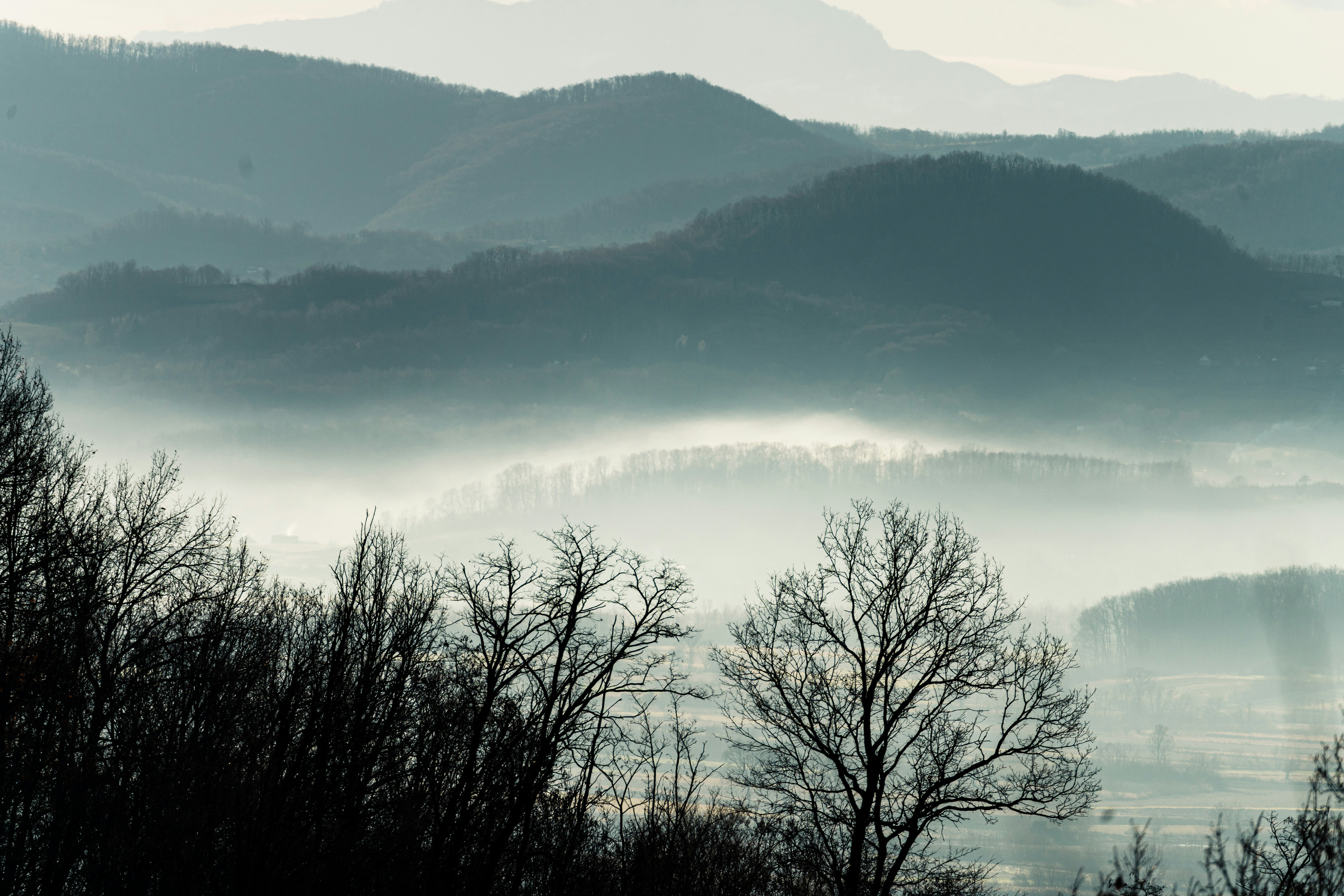 a view of a mountain range covered in fog