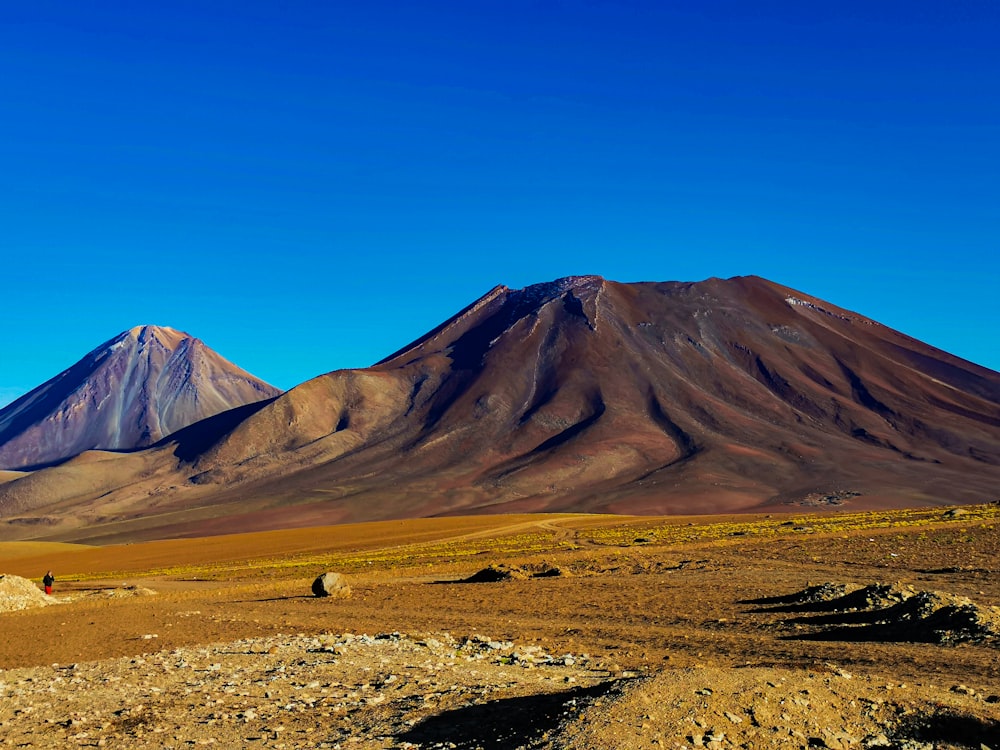 a group of mountains in the distance with a blue sky