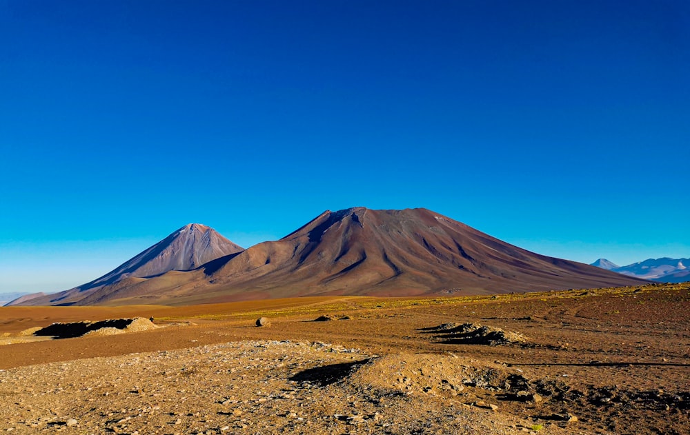 a mountain range in the distance with a blue sky