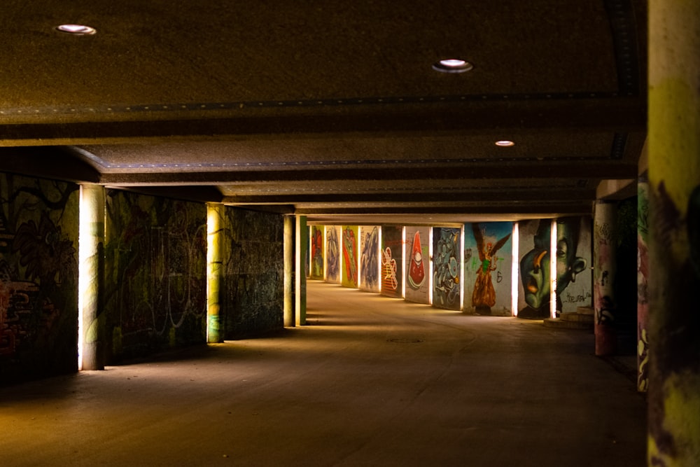 an empty parking garage with graffiti all over the walls