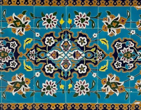 a blue and yellow tile with flowers on it