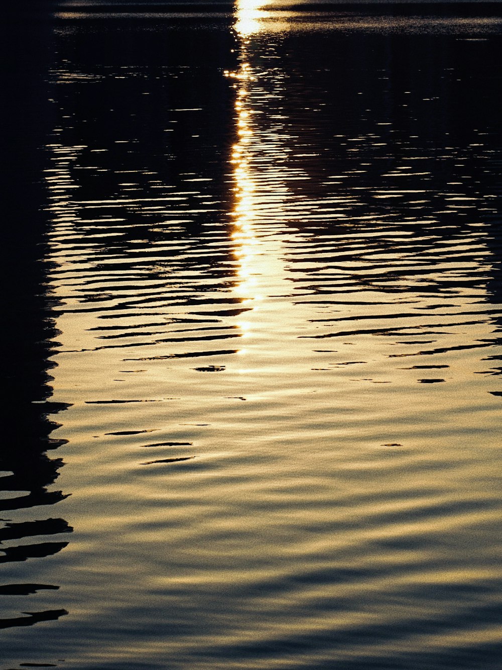 a large body of water with a boat in the distance