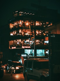 a tall building with lots of windows lit up at night