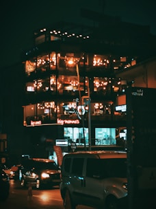 a tall building with lots of windows lit up at night