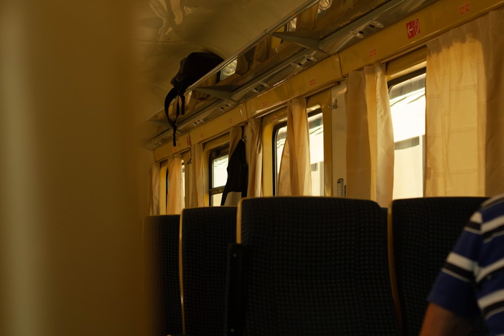 a man standing on a train looking out the window