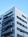 Modern apartment building with balconies overlooking the city skyline.