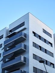 Modern apartment building with balconies overlooking a quiet street in Tirupur.