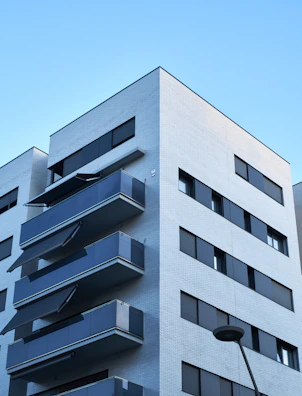 Modern apartment building with balconies overlooking a sunny street in Florida.