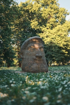 a statue of a man with a beard in a park