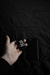 a person holding a smart phone in their hand