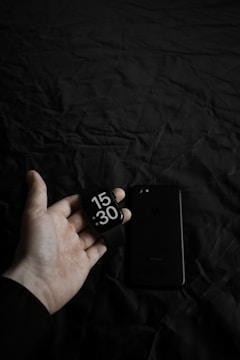 a person holding a smart phone in their hand