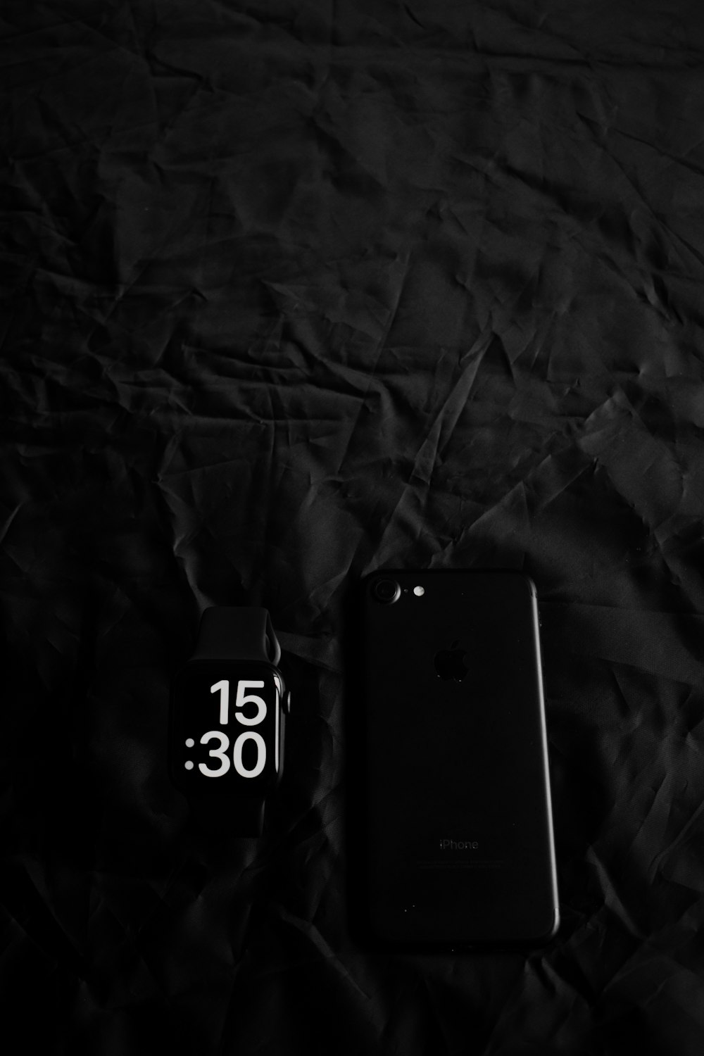 a cell phone sitting on top of a black sheet