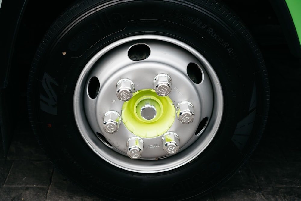 a close up of a tire on a green car