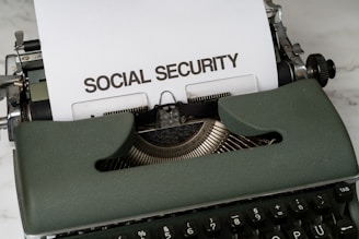 a close up of a typewriter with a paper that says social security