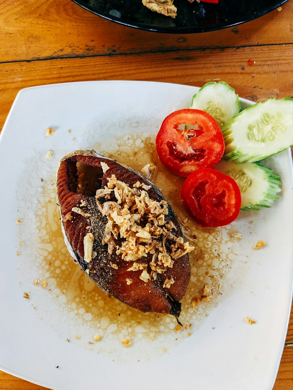 a white plate topped with a baked potato covered in toppings