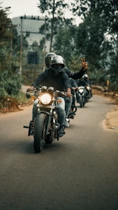 A group of motorcyclists riding together on a scenic country road in Lot-et-Garonne.