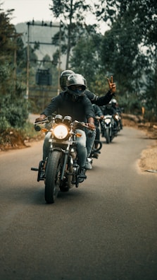 A group of motorcyclists riding together on a coastal highway.