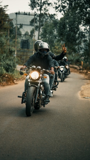 A group of motorcyclists riding together on a scenic country road in Lot-et-Garonne.