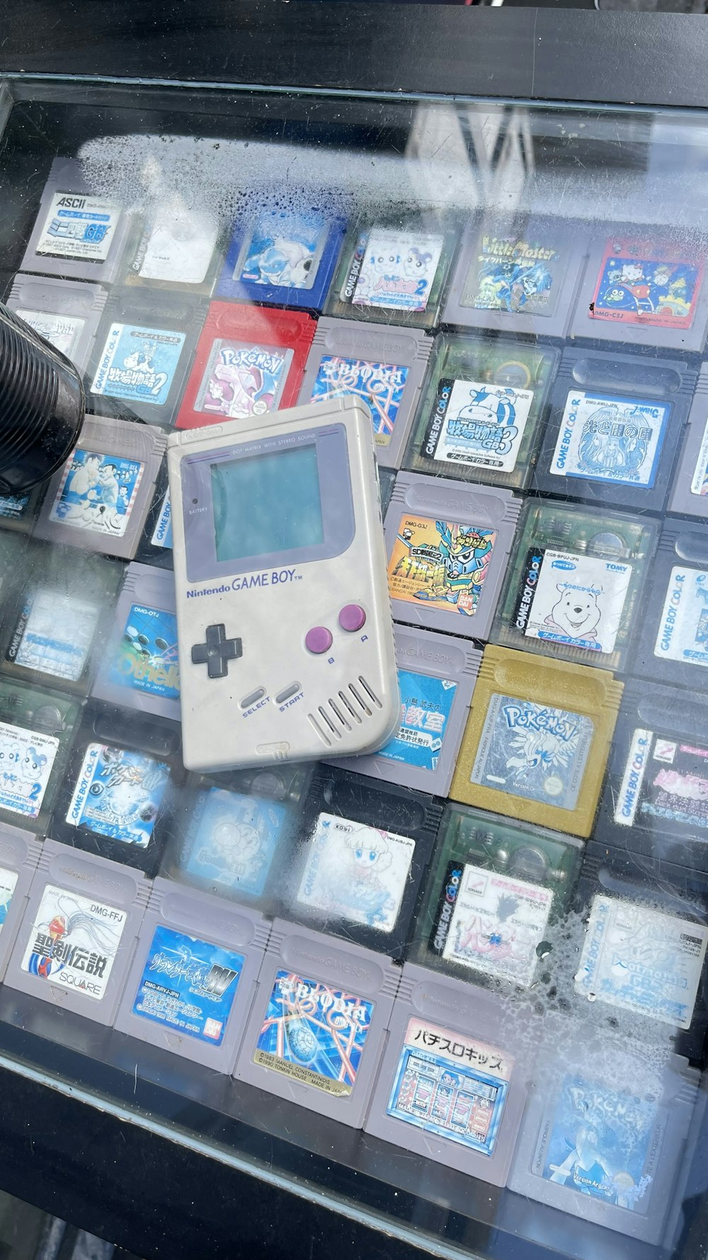 a gameboy on display in a glass case