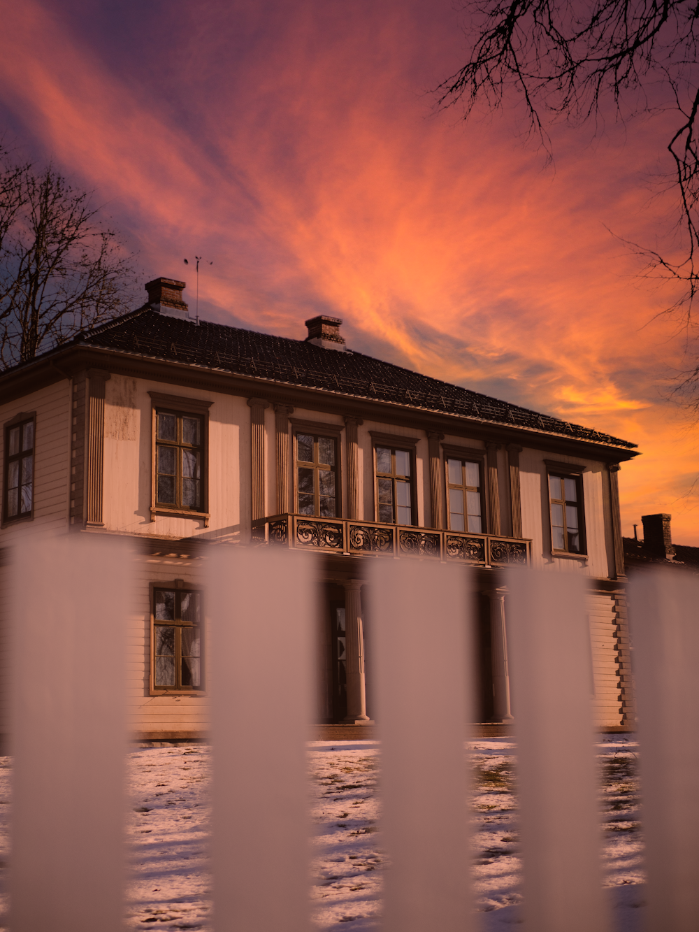 a house with a white picket fence in front of it