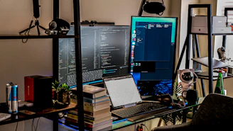 a desk with a computer and a laptop on it
