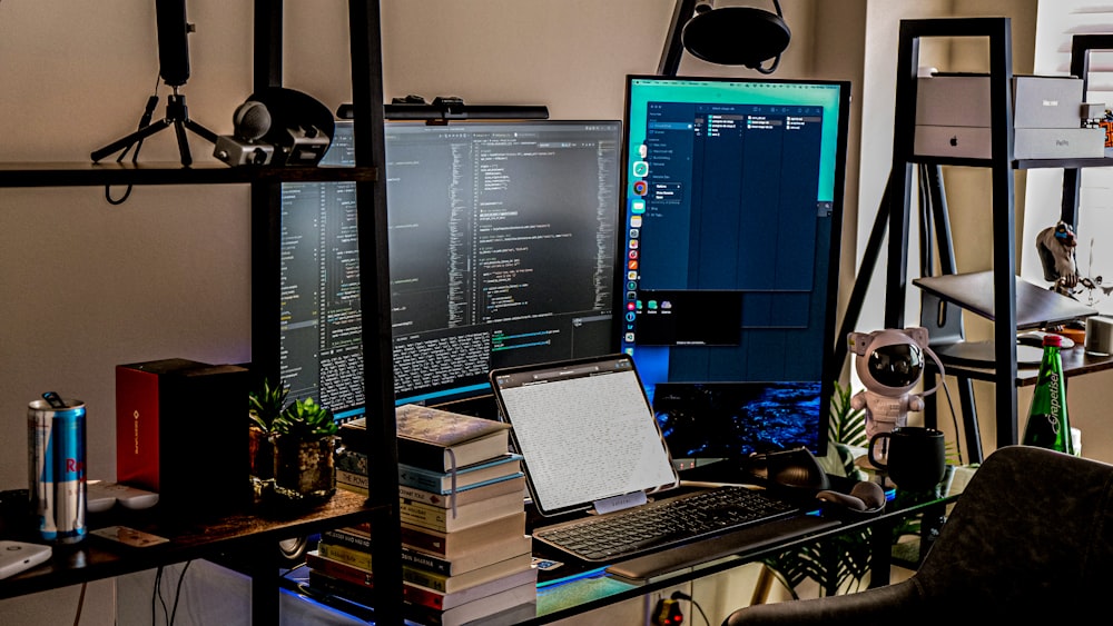 a desk with a computer and a laptop on it