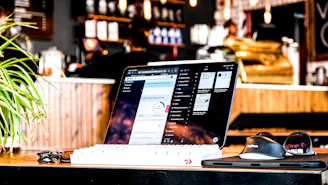 Restaurant bookkeeping and financial management shown with a laptop on a café counter.