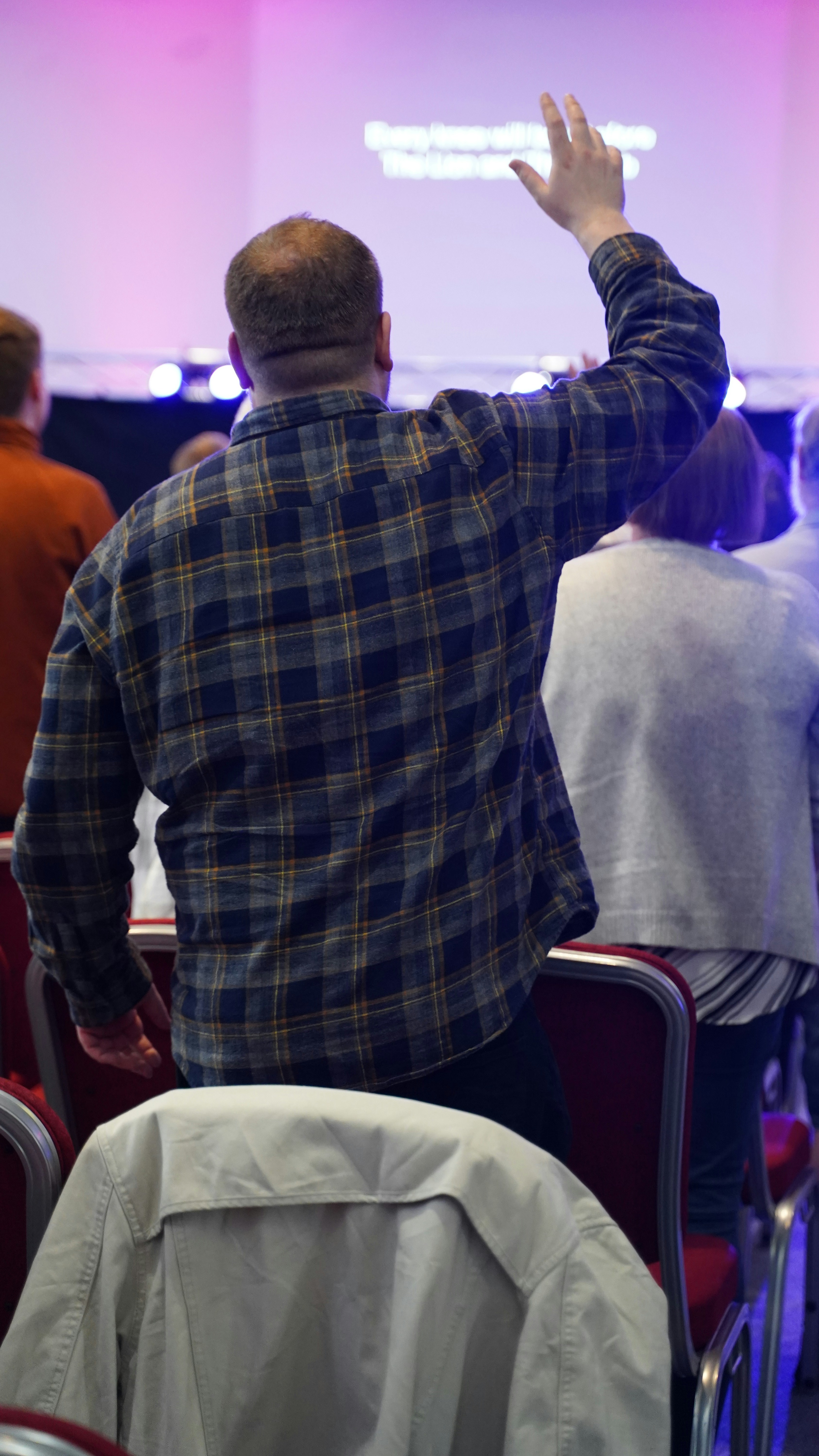a man standing in front of a projection screen