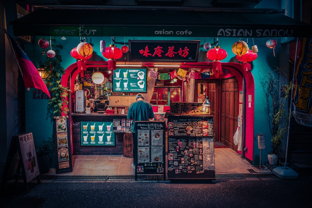 a man standing in front of a restaurant