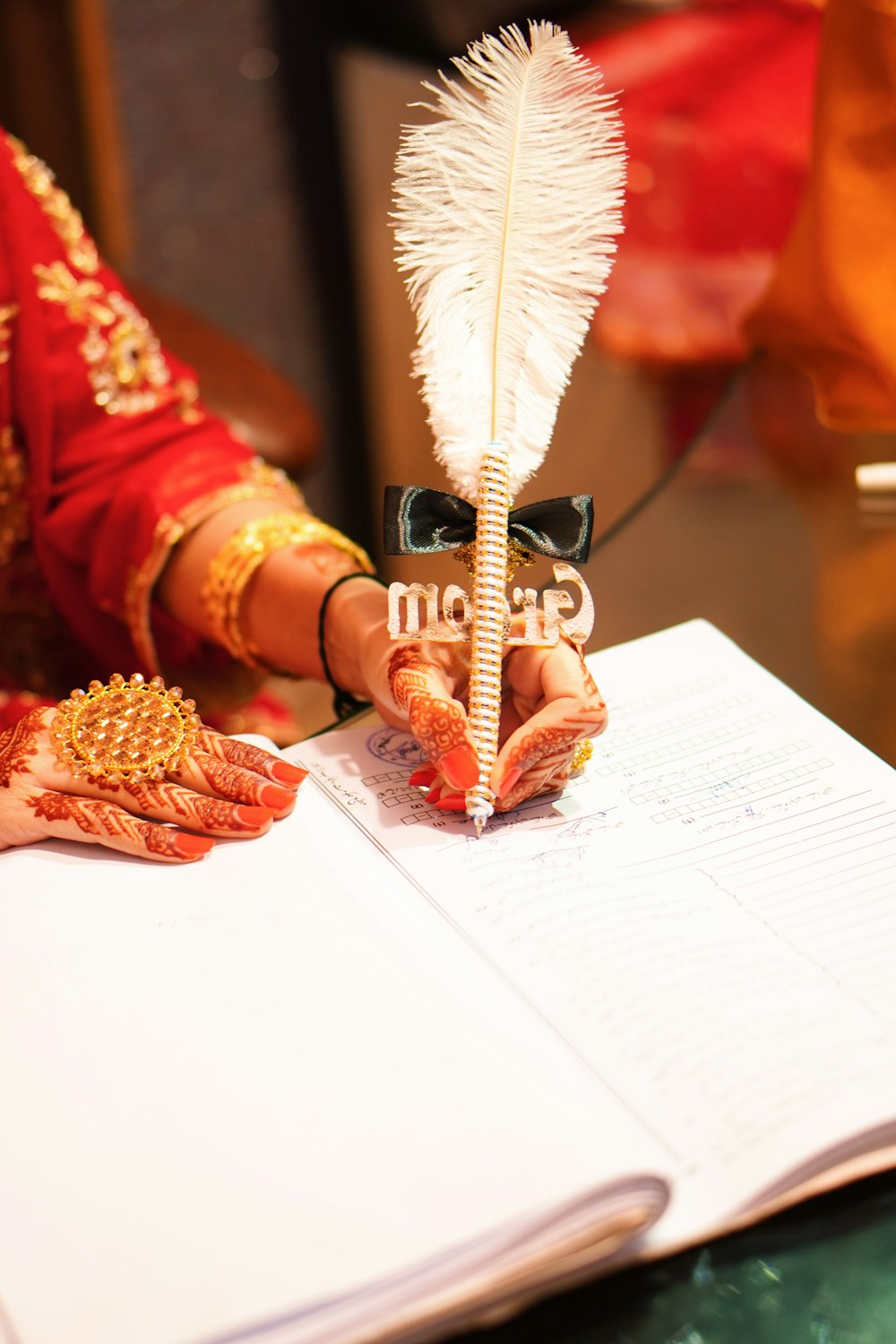 a close up of a person holding a feather